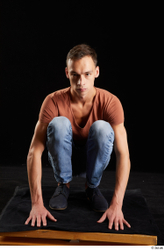 Alessandro Katz  black shoes blue jeans brown t shirt casual dressed kneeling whole body  jpg